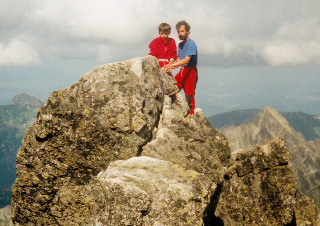 old pic of man and boy on rocky summit