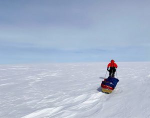 A skier manhauls across Antarctica.