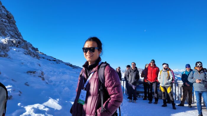 A group of people in outdoor clothing on a snowy plateau. 