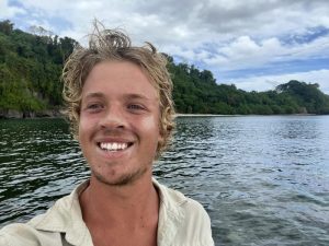 Tom Robinson smiles into the camera as he lands in Vanuatu.