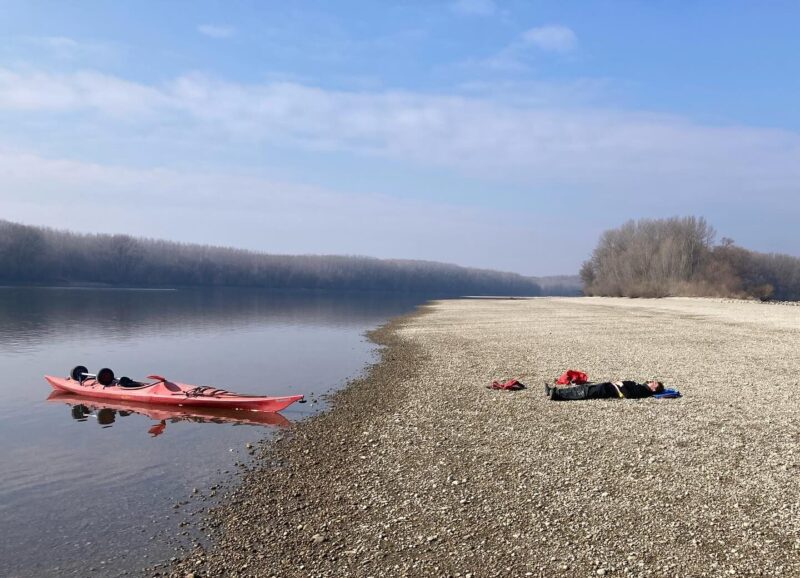 kayaks beached along a sandy shore