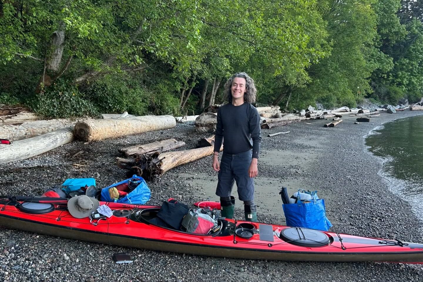 kayaker beside his red kayak