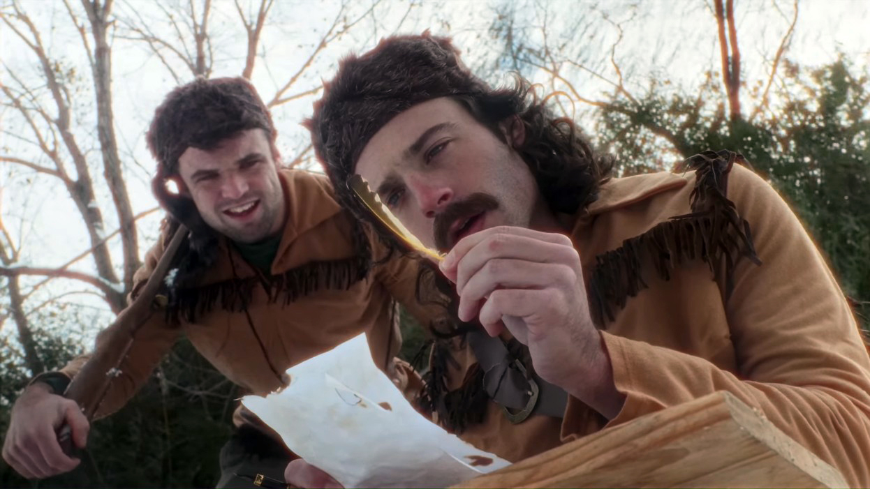 two guys look at a feather