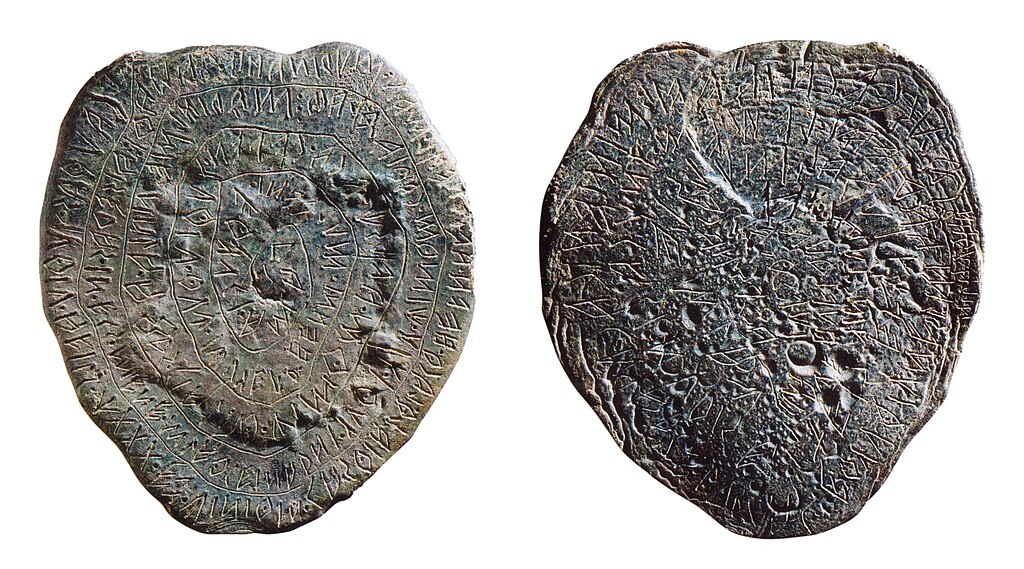 A shield shaped lead tablet with spiral writing