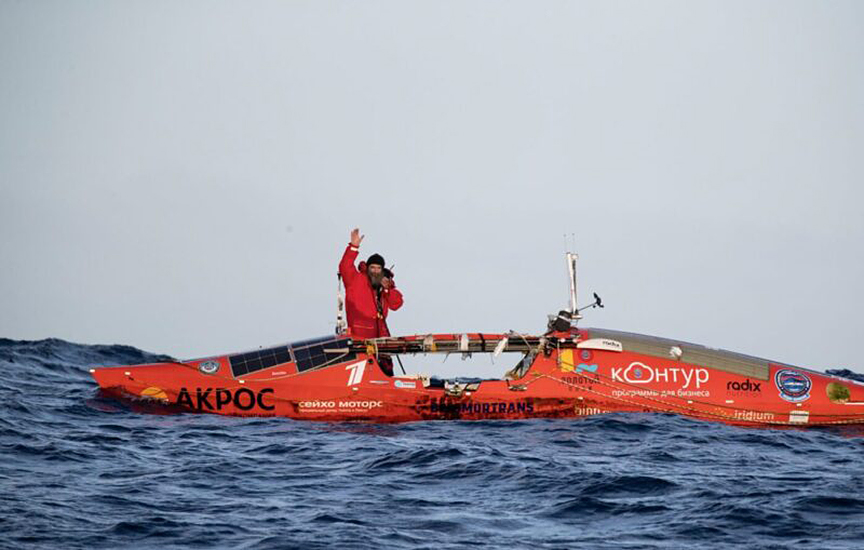 oeann rower poses in boat