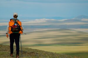 hiker overlooking arctic prairie