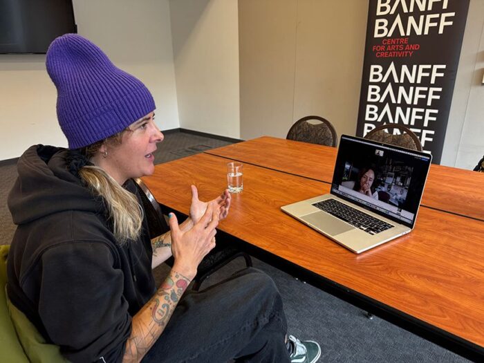 Chantel Astoga explaining something in front of a screen during a zoom interview