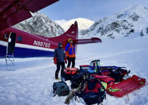Two climbers and their equipment are left on the snow by a Talkeetna air taxi.