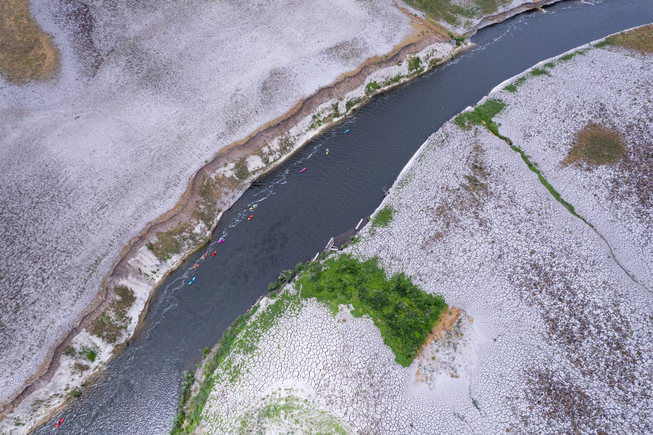 Kayakers in a river from above