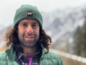 Close shot of Elias Millerioux in Banff wearing a green beanie.