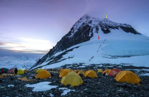 South Col Glacier ice core (8220 m) (red arrow) and Balcony AWS (8430 m) locations (yellow arrow) with South Col camp in the foreground - looking North. The South Col AWS is 500 m South of the camp (outside this picture). Picture by Mariusz Potocki.