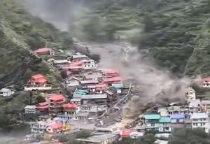 A mountain village in India being swept by a flash flood.