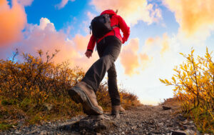 hiker against sunset sky