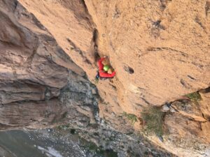 climber on brown wall