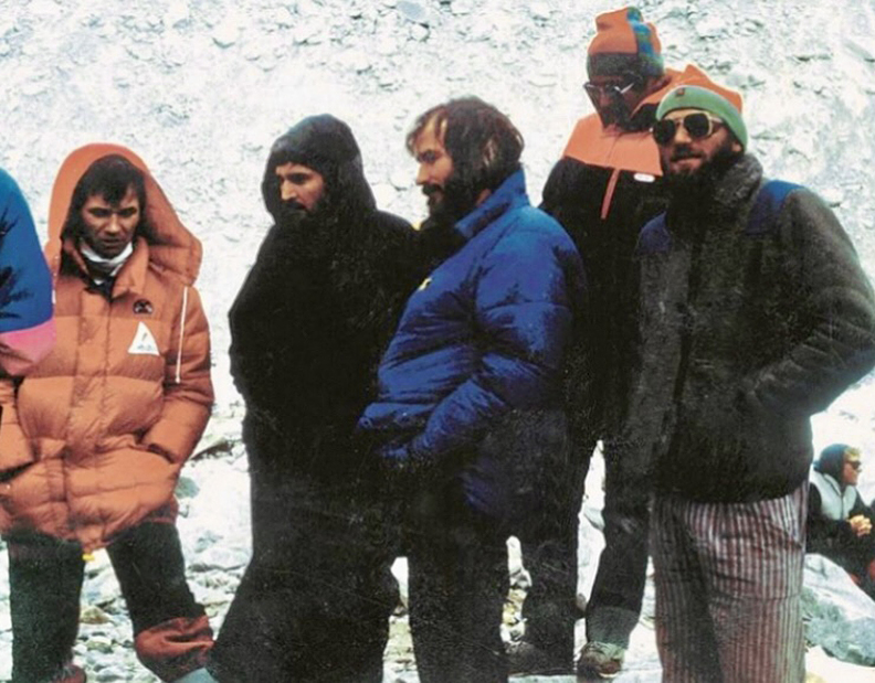 archival photo of several mountaineers standing around base camp