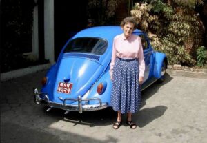 Elizabeth Hawley with her light-blue VW.