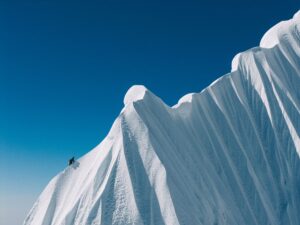 A climber on a huge snow ridge.
