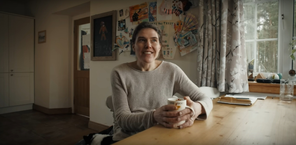 A woman, Jasmin, sitting in her kitchen.