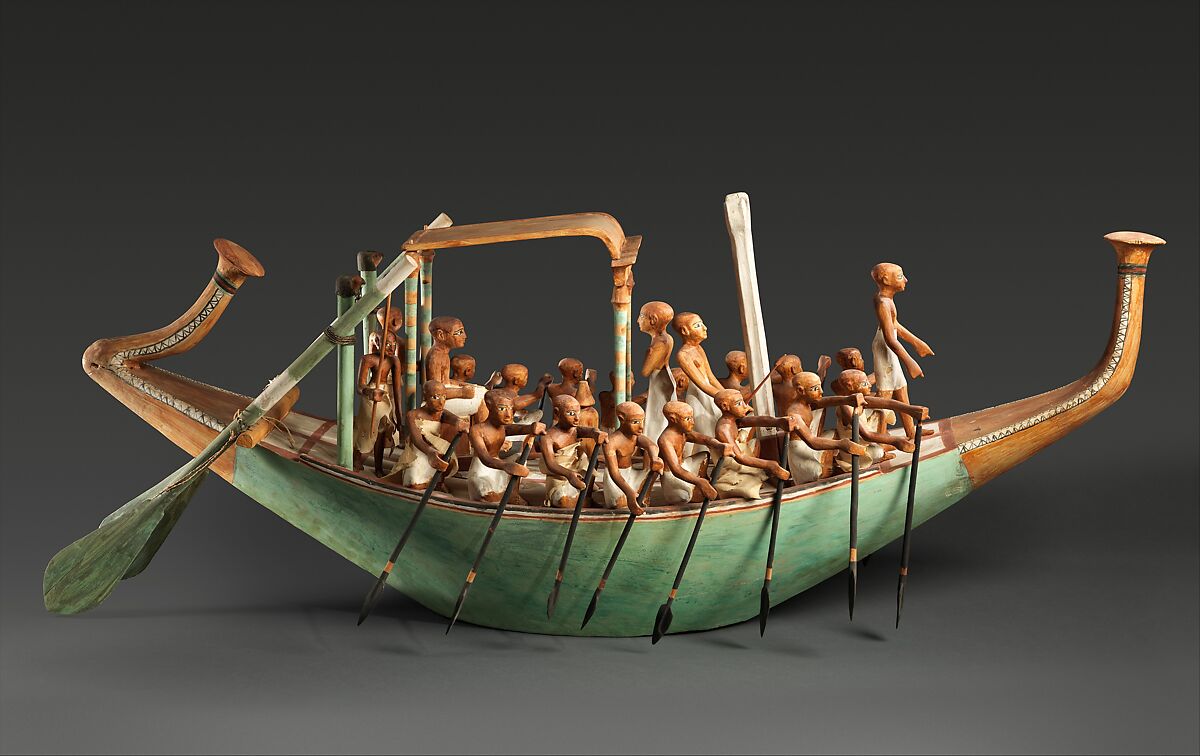 A model of a boat with rowers