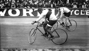 black cyclist racing white cyclist