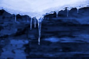 Icicles Hanging From The Snowy Roof