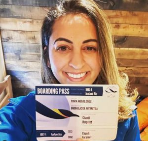 Preet Chandi holding an airline ticket to Antarctica.