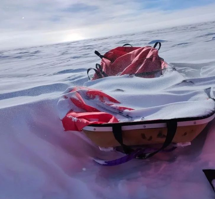 A sled in Antarctica covered in snow.