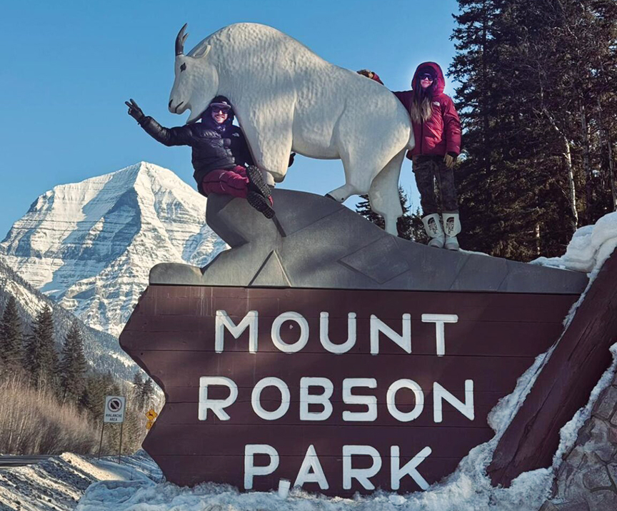 two figures on park sign