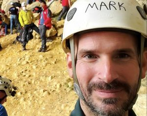 mark dickey, caver, wearing a helmet with his name on it