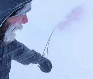 hauling a red kayak through a whiteout