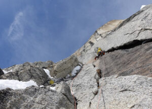 climber high on a granite cliff