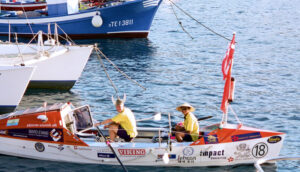 two ocean rowers in rowboat in port