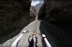 cyclist's arms as he races through mountaIn canyon