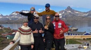 6 people pose by a Greenland shore
