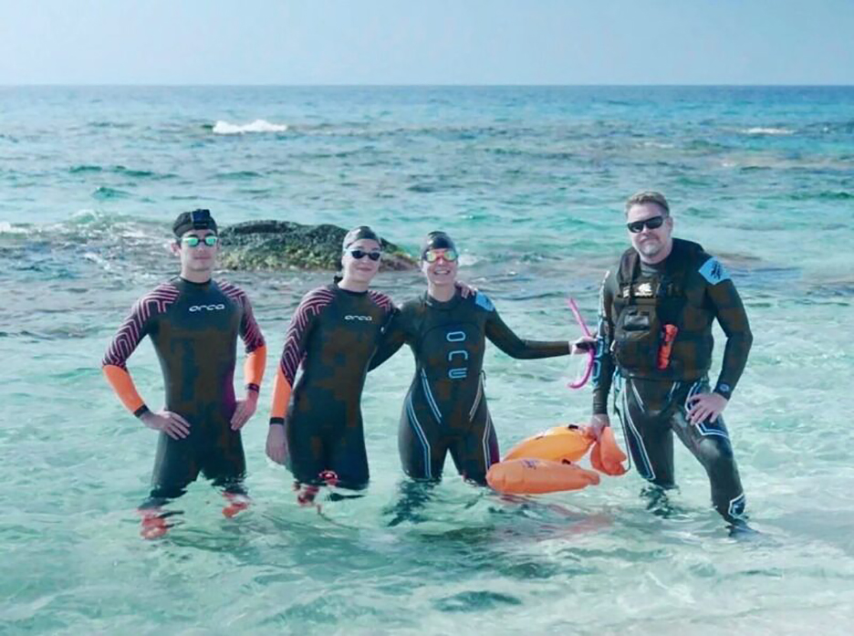 swimmers standing in turquoise water