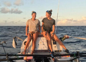 two women in ocean rowboat