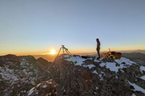 A man measuring the height of a mountain