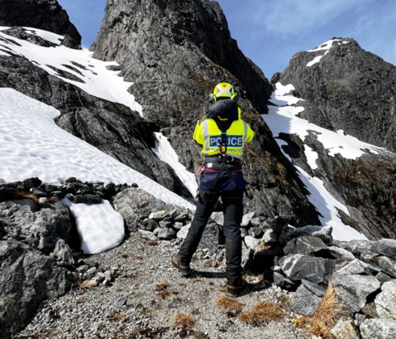 A police search and rescue team member on a mountainside
