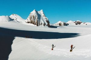 skiers from Vinson of Antarctica passing over snow through mountains