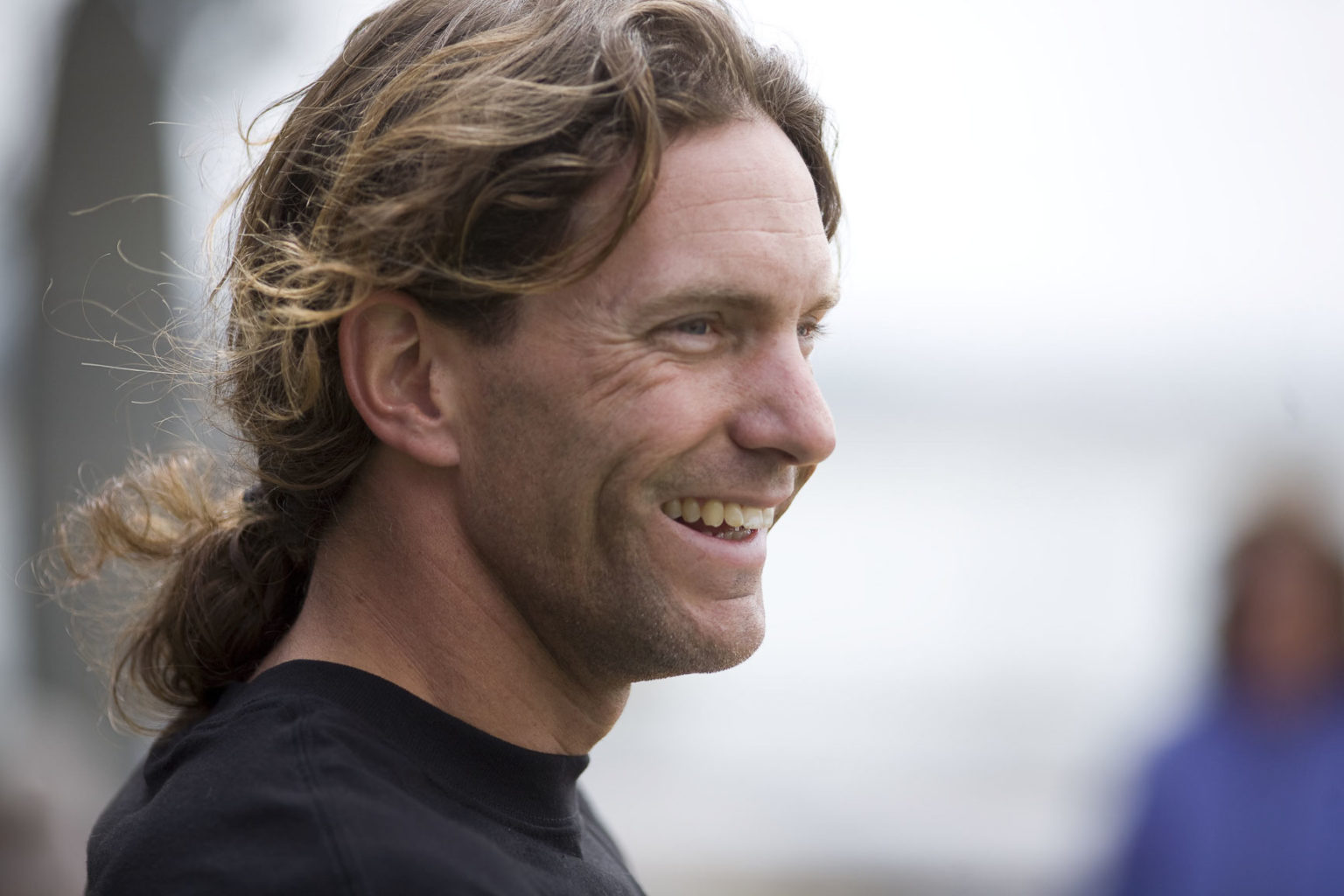 A man smiling broadly.