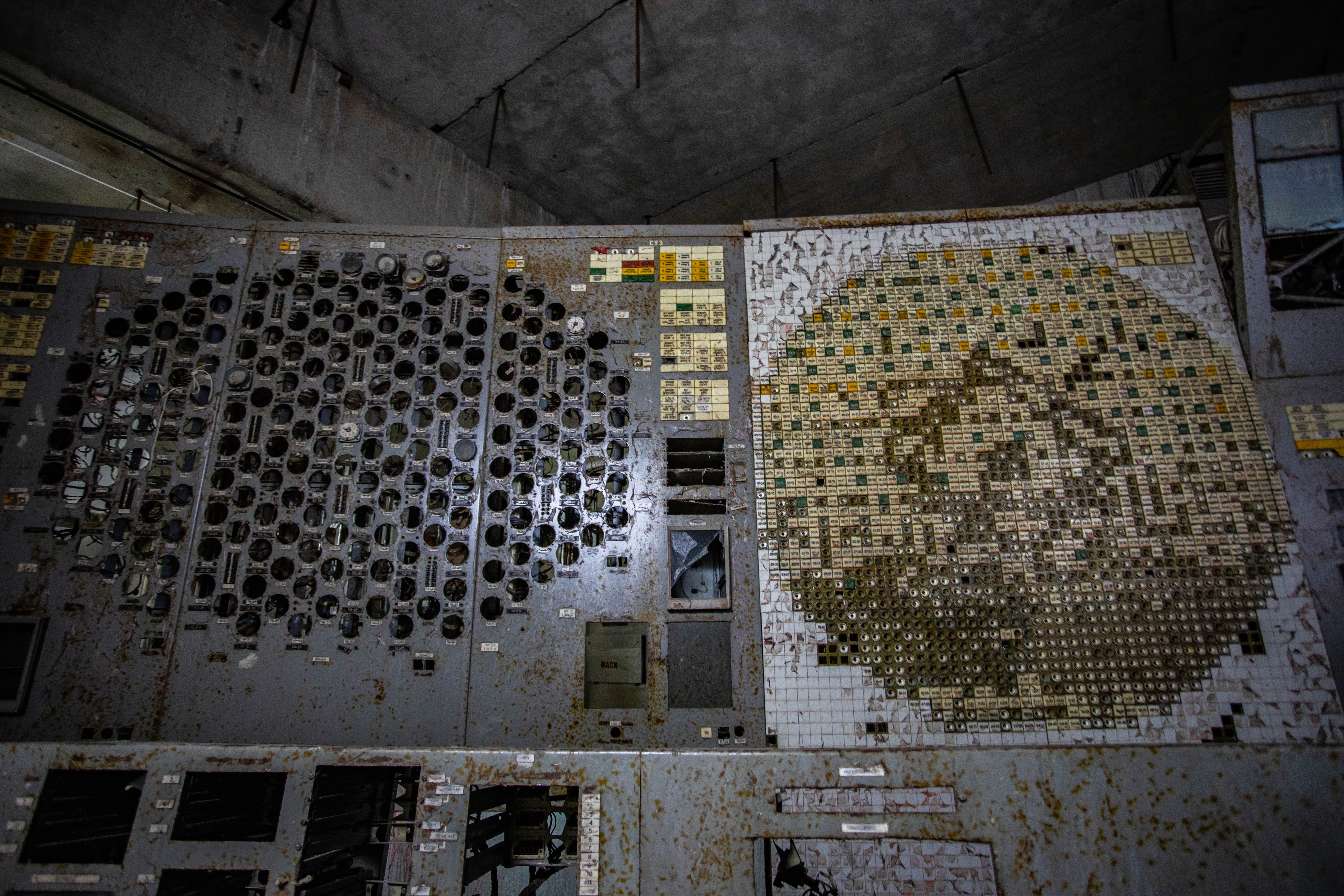 A dingy concrete room with old elecronic equipment