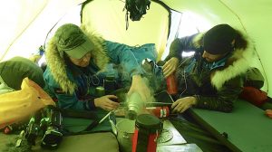 cooking inside the tent on a polar expedition
