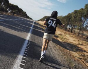 A man running down the road in the outback