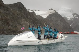 Five rowers in a boat at the end of the trip