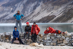 climbers beside a mountain lake