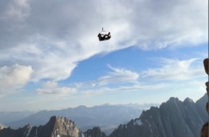 an injured climber being airlifted over mountains